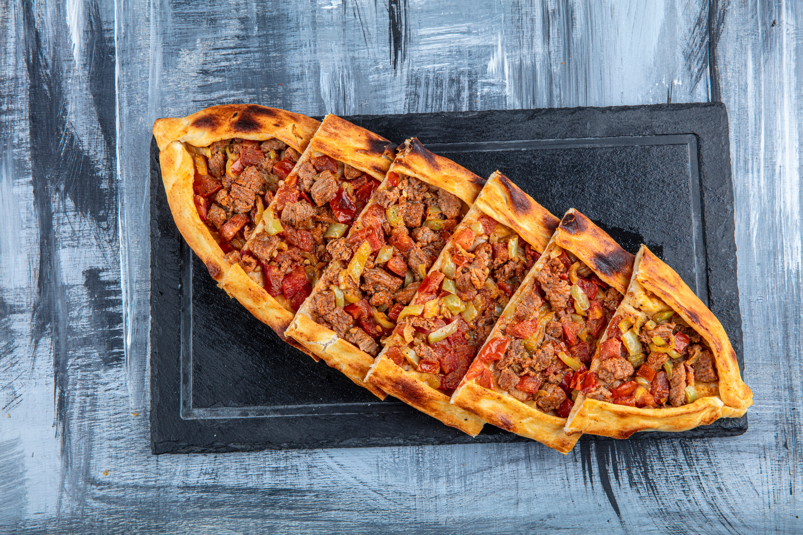 Traditional Turkish Cuisine; pide with cubed meat / kusbasili pide.Turkish pita concept.